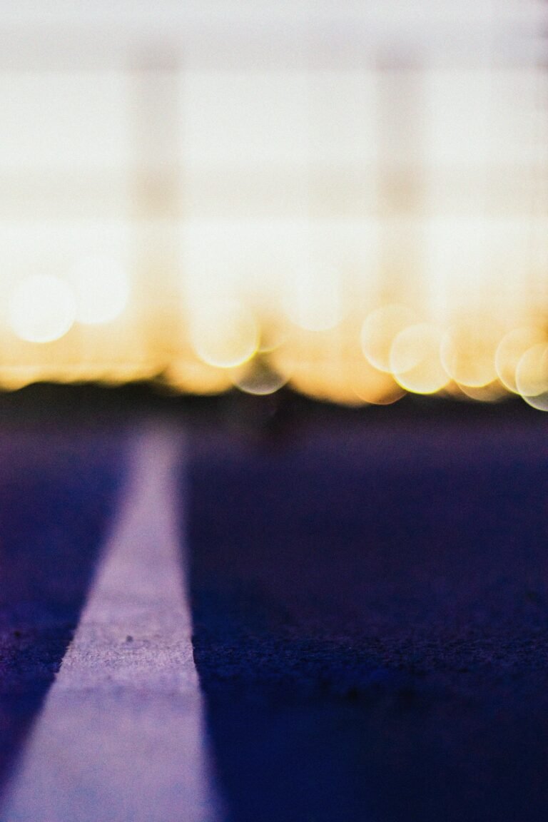 a blurry photo of a street with a stop sign